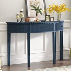 a blue console table with yellow flowers on top