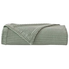 the green and white checkered bedspread is folded up