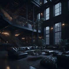 a large living room filled with black leather furniture and lots of windows at night time