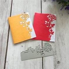 three different types of paper cut outs on a white wooden surface with flowers in the background