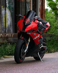 a red and black motorcycle parked on the street