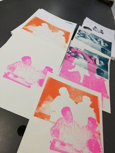 four different colored paper pictures on top of a table