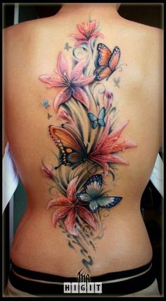 the back of a woman's body with butterflies on it and flowers in the middle