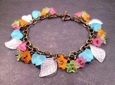 SALE Bracelet - was $26, now $23 Trios of pink, green and orange acrylic blossoms (9mm) with aqua blue hearts and white leaves, along a 7mm link brass chain with a toggle clasp. Bracelet fits up to a seven inch wrist (fits most) but can be altered slightly, upon request. See more of my jewelry designs here: justCHARMING.etsy.com And please visit my sister~shops; justEARRINGS.etsy.com & BohoDreamJewelry.etsy.com All of my jewelry shops offer FREE SHIPPING! Highlights: handmade jewelry, charm bracelet, brass chain, colorful flowers, aqua blue hearts, white leaves, women fashion gift, free shipping Flower Charm Bracelet, Lucite Flower Earrings, Bead Lace, Rose Gold Chain Necklace, Toggle Clasp Bracelet, Bracelet Rainbow, Shrinky Dink, Acrylic Flower, Leaf Bracelet