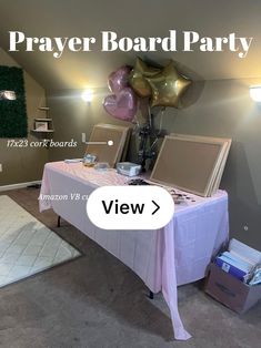 a table with balloons and other items on it in a room that says prayer board party