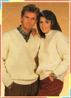 a man and woman in sweaters posing for a photo