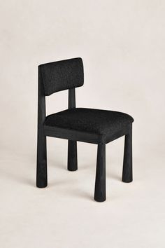 a black chair sitting on top of a white floor