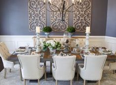 the dining room table is set with white chairs