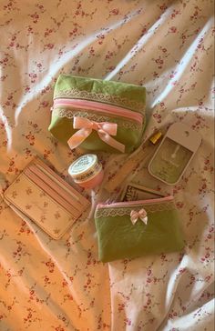 three small purses are laying on a bed