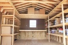 an unfinished room with shelves and boxes in it