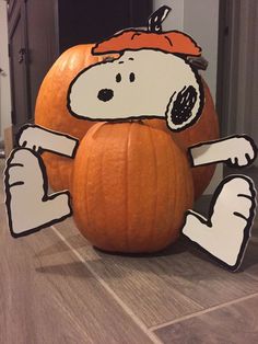 a large pumpkin with a cartoon character on it's face and hands in the shape of a dog