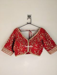 Stunning red blouse in upada silk with gold thread and sequin embroidery. It has hooks on the front and the sleeves are elbow length. This blouse is a versatile piece that can be paired with a sari or a lehenga to  make a perfect festive outfit. This blouse can be made in ANY COLOR. Pls send us a convo if you want it in a different color.  MEAUREMENTS & CUSTOMIZATIONS This blouse can be purchased in your standard sizing and pattern. Please choose your Chest Size (measured in inches) from the drop-down box. This blouse can be customized. We can make in any color, size and pattern.  Incase you need any customizations, please drop us a convo. For custom sizing please include the below measurements in the the notes to whenever you placed the order.  * Chest size: * Waist size: * Blouse Length: Red Silk Traditional Wear With Dori Work, Red Party Blouse Piece With Dori Work, Red Semi-stitched Blouse For Wedding, Red Blouse For Navratri Party, Red Traditional Drape Blouse For Reception, Red Bollywood Blouse For Party, Traditional Red Party Tops, Red Festive Top For Reception, Red Festive Top For Receptions