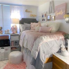 a bedroom with pink and white decor on the walls