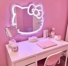 a desk with a hello kitty mirror on it