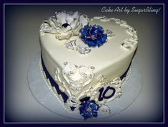 a white cake with blue flowers on top