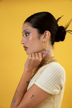 Swing into style with our Chain Orbit Earrings! Featuring dangling chains that orbit around your ears, these earrings add a playful touch to any outfit. They're the perfect accessory for those who like to have fun and not take themselves too seriously. Order now and let the good times orbit! 18k gold-plated or Stainless Steel Lightweight | hypoallergenic | 2" drop Handmade in Los Angeles Follow these tips to keep your jewelry looking its best! Trendy Party Earrings With Chain Detail, Trendy Earrings With Adjustable Chain For Party, Trendy Party Earrings With Adjustable Chain, Party Hoop Earrings With Dangling Charms, Trendy Dangling Charms Earrings For Party, Face Jewellery, Nameplate Necklace, Rosary Necklace, Lip Ring