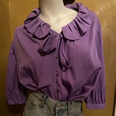 Beautiful Blouse 18w Has A Tie In The Front Copper Buttons The Collar Is Accented With Ruffles New Without Tags Purple Blouse With Ruffled Collar, Purple Ruffled Collar Blouse With Ruffles, Purple Tops With Ruffles And Ruffled Collar, Feminine Purple Blouse With Ruffles, Spring Purple Collared Blouse, Spring Purple Blouse With Collar, Purple Blouse For Fall Daywear, Daywear Ruffled Tie Neck Blouse, Daywear Tie Neck Blouse With Ruffles