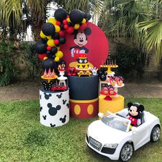 a mickey mouse birthday party with cars and balloons