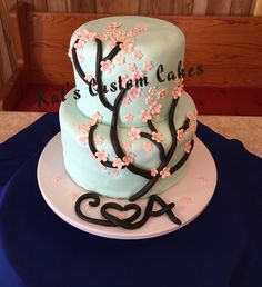 a blue cake with pink flowers on it