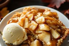 a piece of apple pie on a plate with ice cream