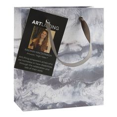 a gray and white bag with a tag attached to it that says arti string