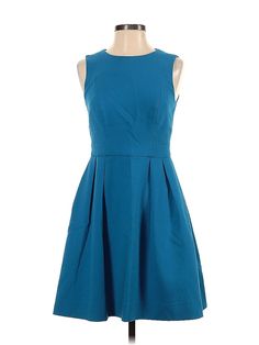 a blue dress on a mannequin dummy with the back turned to show it's pleaed skirt