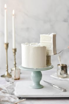 a white cake sitting on top of a plate