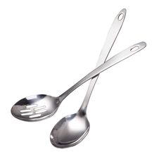 two metal spoons sitting next to each other