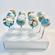 there are many blue and white lollipops with shells on them