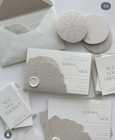 the wedding stationery is laid out on top of each other