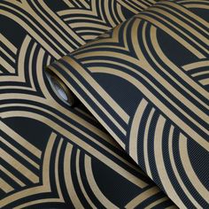 a black and gold wallpaper with an abstract design on it's surface,