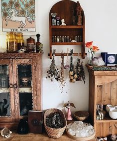 a wooden cabinet sitting next to a shelf filled with jewelry