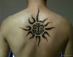 a man with a sun tattoo on his back