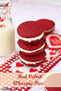 red velvet whoopie pies are stacked on top of each other with a glass of milk in the background