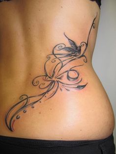 a woman's stomach with a bird tattoo on it