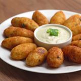 a white plate topped with tater tots and dip