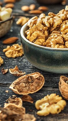 a bowl filled with nuts on top of a wooden table