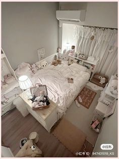 a bedroom with white furniture and teddy bears on the bed