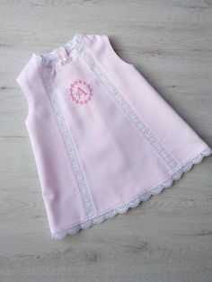 Personalized baby girl dress. Made of light pink piqué with embroidered strip details. It does not have a lining. We can personalize the dress by embroidering the initial letter of your baby's name. Available in various sizes. If you have any questions do not hesitate to contact me Fitted Sleeveless Pink Baptism Dress, Elegant Summer Baptism Dress In Pink, Elegant Pink Summer Baptism Dress, Embroidered Pink Baptism Dress, Pink Embroidered Dress For Baptism, Pink Embroidered Dresses For Baptism, Girl Baptism Dress, Baptism Dress Baby Girl