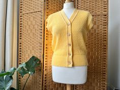 "A really sweet pastel yellow sleeveless cardi, lovely as a layer & fab on its own too. Bust measures approx  up to 38\", 31\" shoulder to hem. Excellent condition" Vintage V-neck Vest For Spring, Spring V-neck Retro Vest, Retro V-neck Spring Vest, Fitted Yellow Vest For Fall, Yellow V-neck Vest For Spring, Yellow Retro Cardigan For Spring, Retro Yellow Cardigan For Spring, Vintage V-neck Sweater Vest For Spring, Fitted Vintage Summer Cardigan