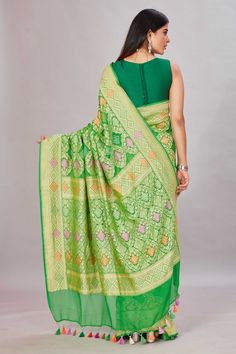 Elegant green georgette Banarasi saree is a perfect choice for festive occasions! It is enhanced with zari minakari jaal and comes with a matching blouse piece. Disclaimer: The shown stitched blouse on the model is for display purpose only. The saree comes with a matching blouse piece and finished with fall and piko. Designer Green Dupatta For Transitional Season, Festive Green Chanderi Pre-draped Saree, Green Semi-stitched Pre-draped Saree With Meenakari, Green Bollywood Pre-draped Saree With Meenakari, Green Blouse Piece With Cutdana For Transitional Season, Green Georgette Pre-draped Saree For Transitional Season, Designer Wear Transitional Green Blouse Piece, Transitional Green Blouse Piece With Cutdana, Green Silk Pre-draped Saree For Eid