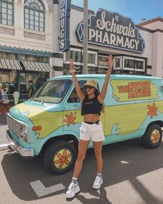 a woman standing in front of a van with the words school's pharmacy painted on it