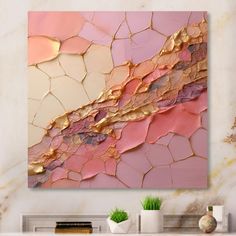 an abstract painting in pink, gold and white on a wall above a fireplace mantel