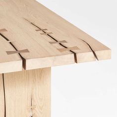 a close up of a wooden table with crosses cut out of the top and sides