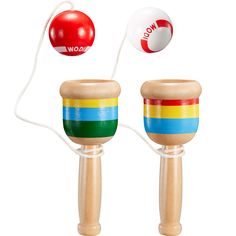 two wooden toy maracases with colorful stripes on the top and bottom one has a red ball in the middle