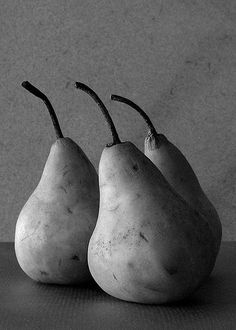 three pears sitting side by side on a table