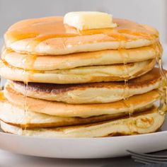 a stack of pancakes with syrup and butter on the top are ready to be eaten