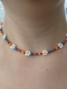 Pretty flower seedbead choker necklace with white flowers and multi coloured rainbow beads. Chose your length from the drop down box.  Hand crafted in a smoke free home. All my items are sanitised before posting.  Silver plated extender chain Cheap Rainbow Necklaces With Colorful Beads, Trendy Multicolor Flower Necklace With Colorful Beads, Multicolor Beaded Necklace With Flower Charm For Summer, Trendy Multicolor Beaded Flower Necklace, Trendy Handmade Multicolor Flower Necklace, Multicolor Beaded Necklaces With Flower Charm, White Flower Necklace With Tiny Beads, White Flower Necklace With Tiny Round Beads, White Flower Necklace With Colorful Beads For Summer