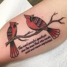 two red birds sitting on a branch with a quote written below the bird is in love