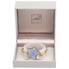 This is part of Chairish’s Costume Jewelry assortment.  Modernist Inspired by the magic of the ocean depths, evokes nature, a theme dear to Maison Lalique. The Raised Blue Textured Starfish of satin & polished crystal subtly captures the light. The French cuff is gold plate over sterling in a Lalique Gift Box. It is a great presentation gift for a loved one!  About the product: *The length is 6.25" *The starfish measures about 1-3/8 inches (3.5 cm) wide and tall. *The name LALIQUE    Is stamped on the back as shown.  Please reference the measurements noted in the description above for the best approximate dimensions. Please reach out to the seller under "Ask the Seller" for specific questions regarding the measurements. Elegant Starfish Bracelet For Gift, Luxury Starfish-shaped Jewelry Gift, Lalique Jewelry, Blue Starfish, Sterling Silver Charm Necklace, Lucite Bracelets, Contemporary Art Deco, Starfish Bracelet, French Cuff